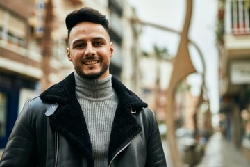 Fototapeta premium Young arab man smiling happy standing at the city.