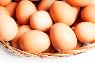 farm bio raw eggs in basket over white isolated background