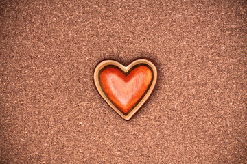 One wooden heart on rustic wood background. Valentines days concept.  Love symbol. Greeting card with copy space.