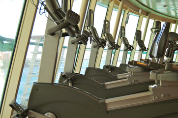 Fitness Center or gym onboard classic cruiseship or cruise ship liner with dated cardio and free...