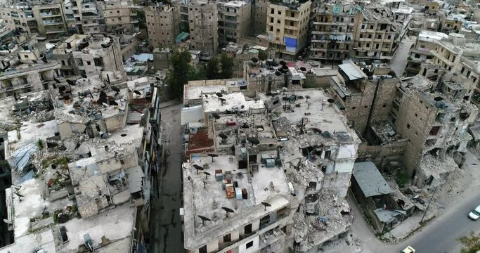 Aerial view over a syrian city. Some of the buildings are still in ruins after the civil war 10 years ago 4K