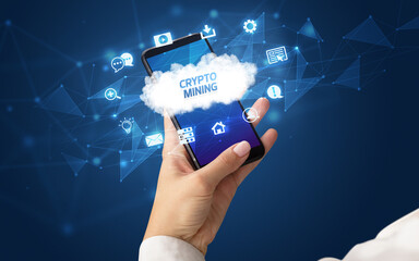 Female hand holding smartphone with CRYPTO MINING inscription, cloud technology concept