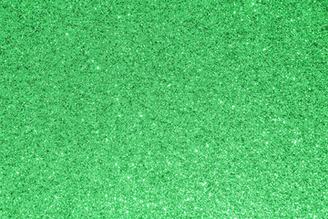 Green glitter texture background for Christmas and Saint Patrick’s day holiday decoration metallic wallpaper backdrop design © Chinnapong