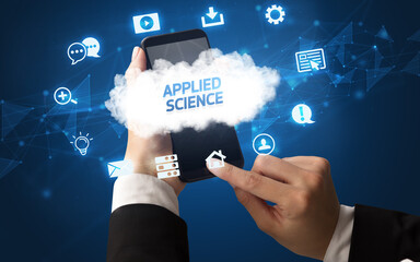 Female hand holding smartphone with APPLIED SCIENCE inscription, cloud technology concept