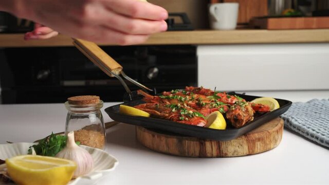 Cooked grilled large queen shrimps with lemon and spices on the grill pan