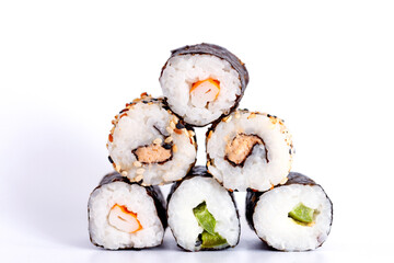 Eating Sushi with chopsticks. Sushi roll japanese food in restaurant isolated on white background. Fresh hosomaki pieces with rice and nori. Closeup of delicious japanese food with sushi roll.
