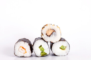 Eating Sushi with chopsticks. Sushi roll japanese food in restaurant isolated on white background. Fresh hosomaki pieces with rice and nori. Closeup of delicious japanese food with sushi roll.