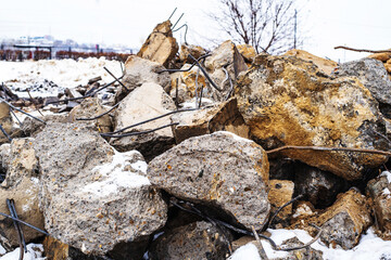 Large concrete stones with metal reinforcement. Construction waste after the collapse of the building. Close-up