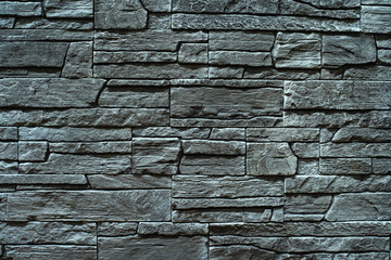 Gray wall made of decorative stone. Facing material for various surfaces. Flat lay frame