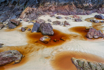 Rocks and sand background. Winter ocean shore in Vancouver, Canada.