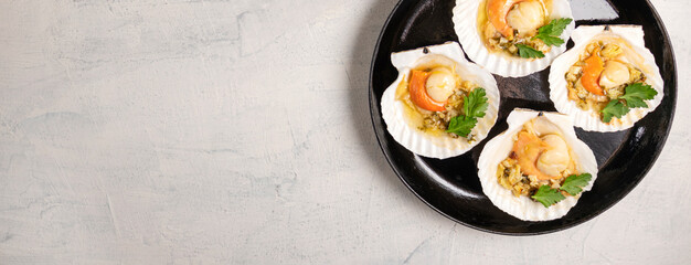 Baked scallops with caviar and creamy garlic sauce. Scallops, lemon, garlic, parsley, butter and salt. Recipe for cooking scallops with caviar. Top view. Copy space.