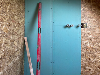 Installation of a new bathroom shower wall in a small home with plasterboard and fireboard, the internal and back parts of the faucet are installed