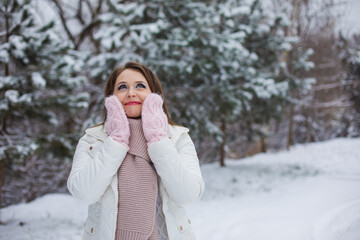 the woman enjoys a walk in the winter park