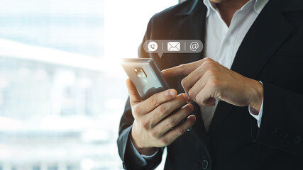 Hand of Businessman holding mobile smartphone. Contact Us, customer support concept. copy space.