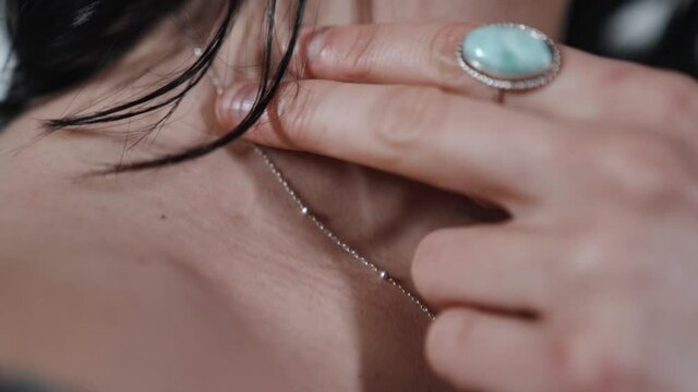 Female Naked Shoulder Close up. Woman Touching Neck With fingers. View from the Front. Woman Wearing Larimar Ring and Silver Jewellery. Slow Motion, Young sexy woman touching body