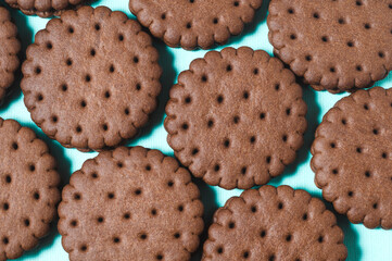 Texture background of rows of chocolate-cream cookies.