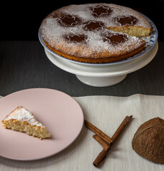 Coconut and lemon cake, covered with powdered sugar and cocoa powder