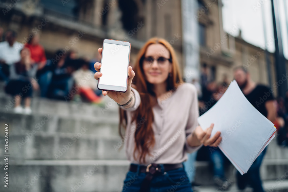 Aufkleber blurred hipster girl with documents showing digital cellular gadget with copy space area for interne