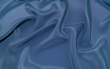 Part of the dark fabric texture of the fabric for the background and decoration of the work of art, a beautiful crumpled pattern of silk or linen. A crumpled piece of cloth