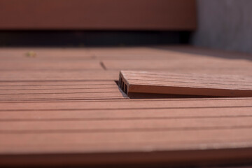 Damaged Plastic Wood boards because of humidity and moisture, bending and come out, image Close-up.