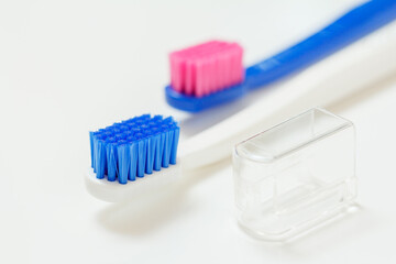 White and blue toothbrushes on the white background.