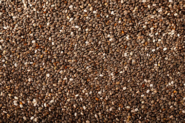 Chia seeds in glassware on a white wooden background with copy space. Chia seeds in a spoon on a white tree.