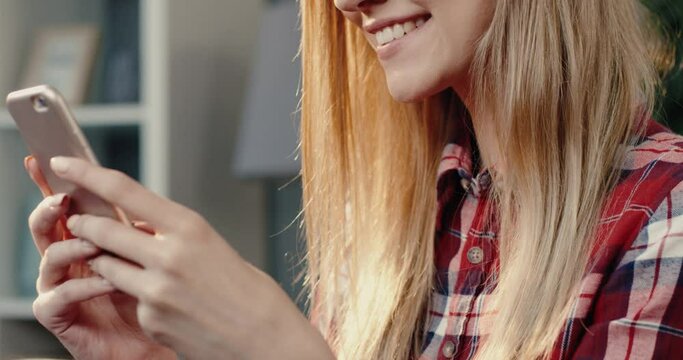 Close up portrait of female young smartphone user spending free time with device searching for information on internet.