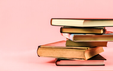 Stacked books on pink background