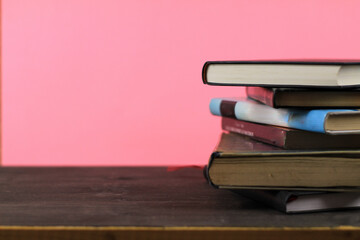 Stacked books on pink background