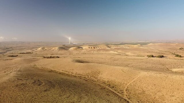 Flight with a rise in height over the Negev Desert in Israel towards the Ashalim solar power plant