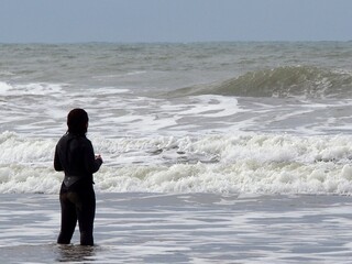 Girl practicing a water sport such as surfing, enjoying a physical activity outdoors