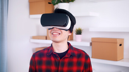 Portrait of young asian man wearing VR headset. High quality photo