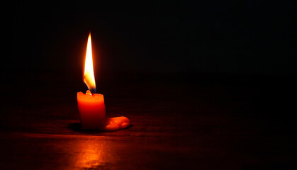 light candle burning brightly,Candle light close up on black background. Burning candle. Candle Flame.	
