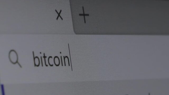 query in the search bar for the word bitcoin. someone types the word bitcoin in a line.