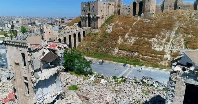 The Citadel of Aleppo from outside. We can see a lot of people going inside the citadel on a pond 4K