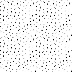 Confetti seamless vector pattern. Repeatable  background with black sprinkles on white.
