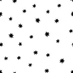 Doodle stars seamless pattern. Chaotic black stars isolated on white background.