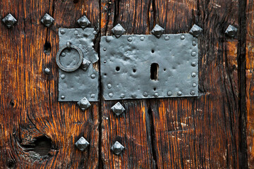 detail of a closed old wooden door and lock