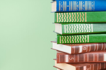 Book stack close up on a green background