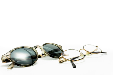 gold eyeglasses and modern sunglasses. isolated