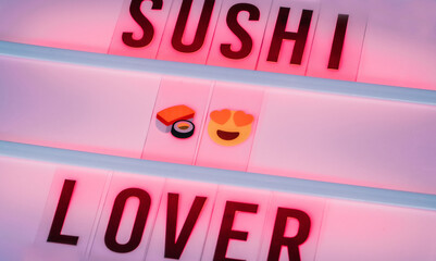 luminous red poster, with the message sushi lover and copy space. selective focus.