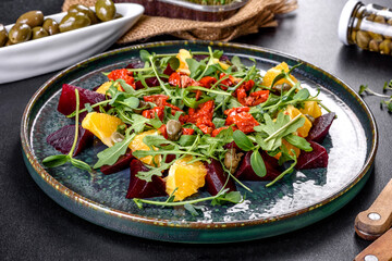 Tasty fresh healthy salad with boiled beets, microgreen and orange