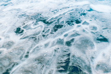 Aerial view of frozen lake. Ice from drone view. Winter landscape with clear smooth ice.