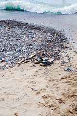 Sandals on the foreshore left by people who dived into the sea. 