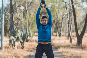 man lifting weights outdoors