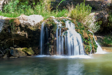 Beautiful waterfall with view between mountains and trees