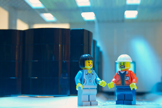 A man and a woman working in a data processing center, diorama recreated the concept with lego figures