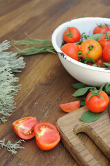 Organic tomatoes in bowl on board