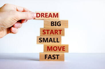 Dream big start small symbol. Words 'dream big start small move fast' on wooden blocks on a beautiful white background. Businessman hand. Business, motivational and dream big start small concept.
