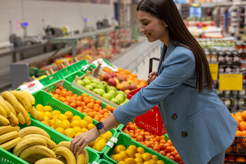 A young woman is buying fruits in the supermarket.